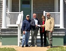 Midgett Realty's Tim Midgett and Susie Midgett Austin (center) present a check for $5,000 to Chicamacomico Historical Association President John Griffin (left) and Treasurer Ralph Buxton (right) to help support the Mirlo Centennial Commemoration Aug. 13-17, 2018. (CHA photo)