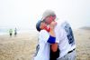 Tommy & Gila Hodge, winner of the 2015 MR Photo Contest share a moment after running the 2016 Memorial Day Shore Break 5K Sponsored by Midgett Realty