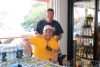 Owner Charles Graham hangs out with local, Jarvis Williams, during an afternoon at Village Market
